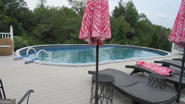 view of pool with a wooden deck