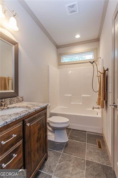 full bathroom featuring vanity, tile patterned floors, crown molding, bathing tub / shower combination, and toilet