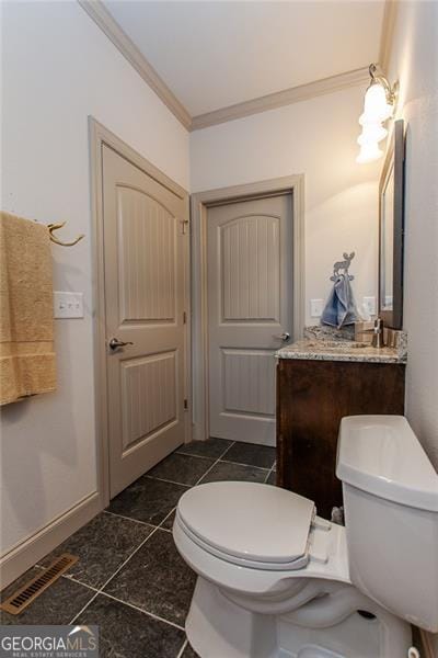 bathroom with vanity, toilet, tile patterned floors, and crown molding