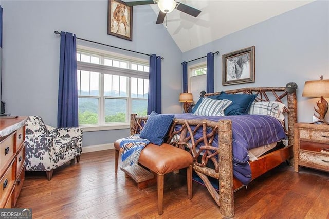 bedroom with dark hardwood / wood-style flooring, lofted ceiling, and ceiling fan