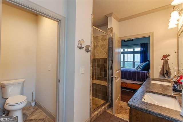 bathroom with a shower with door, dual sinks, tile patterned floors, toilet, and ornamental molding