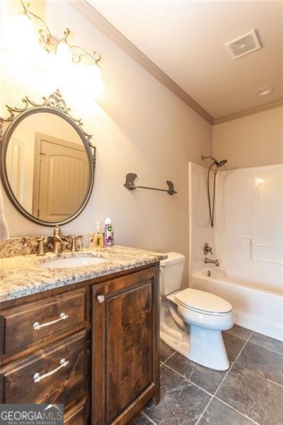 full bathroom featuring vanity, crown molding,  shower combination, toilet, and tile patterned flooring