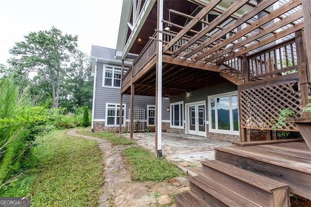 back of property with a patio area, a deck, and french doors