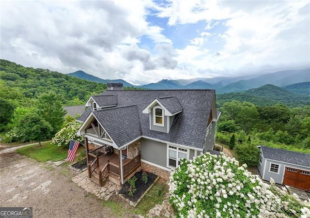 view of front of property featuring a storage unit and a mountain view