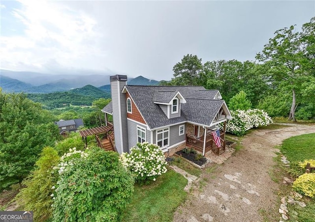 view of front of property featuring a pergola and a mountain view