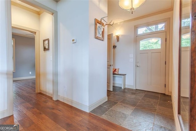 entrance foyer featuring crown molding and dark hardwood / wood-style floors