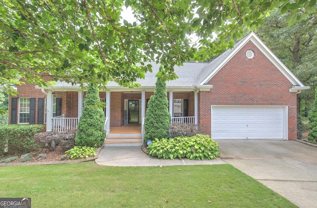 view of front of house featuring a garage, a porch, and a front yard