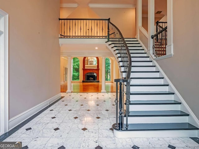 staircase with wood-type flooring and ornamental molding