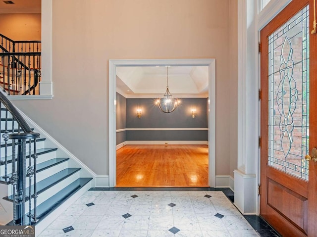 foyer entrance with hardwood / wood-style floors and a chandelier