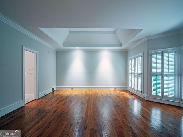 unfurnished room with ornamental molding, hardwood / wood-style flooring, and a raised ceiling