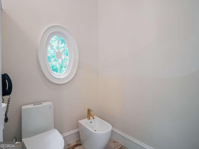 bathroom featuring a bidet, toilet, and tile patterned floors