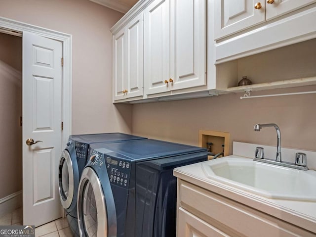 washroom featuring sink, cabinets, separate washer and dryer, and light tile patterned flooring