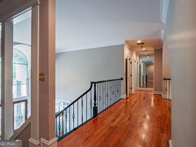 hallway featuring ornamental molding and hardwood / wood-style floors