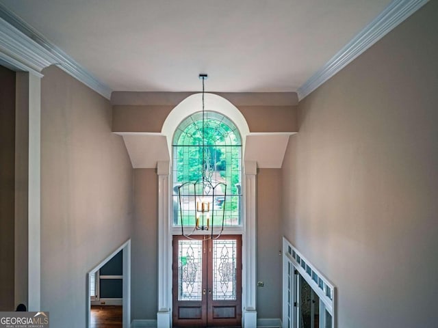 entryway with crown molding, french doors, and hardwood / wood-style floors