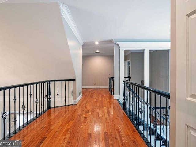 corridor with ornamental molding and wood-type flooring