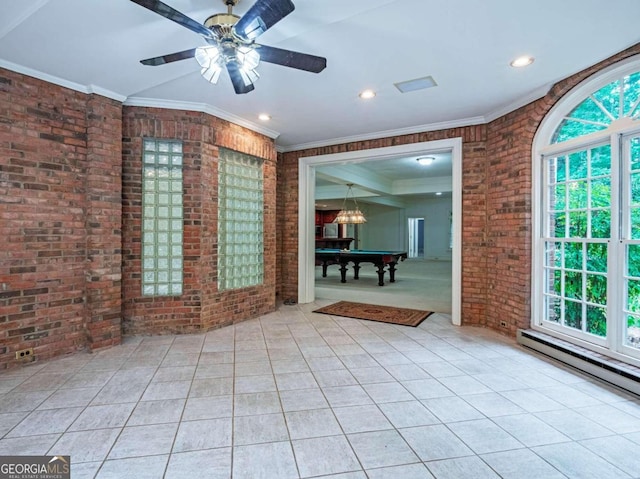 tiled empty room with brick wall, ceiling fan, a healthy amount of sunlight, and pool table