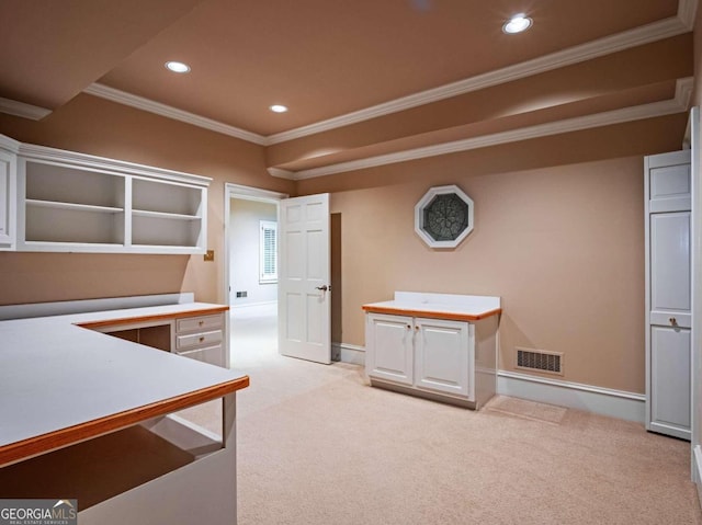 interior space featuring crown molding, light colored carpet, and white cabinets