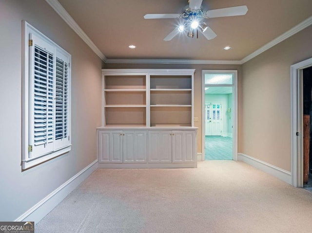 unfurnished living room with carpet floors, ceiling fan, and crown molding