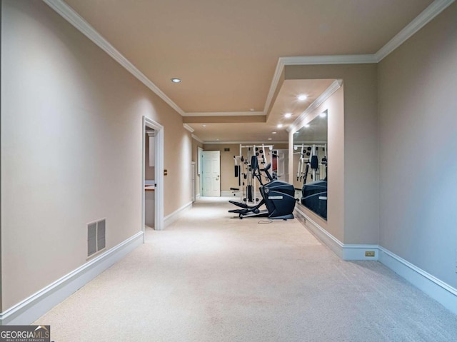 workout room with ornamental molding and carpet floors