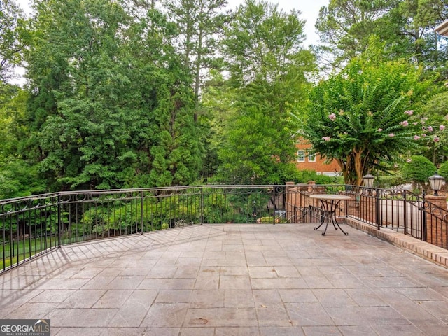 view of patio featuring a balcony