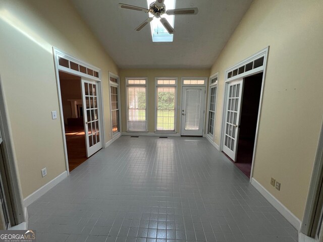 unfurnished sunroom with lofted ceiling, french doors, and ceiling fan