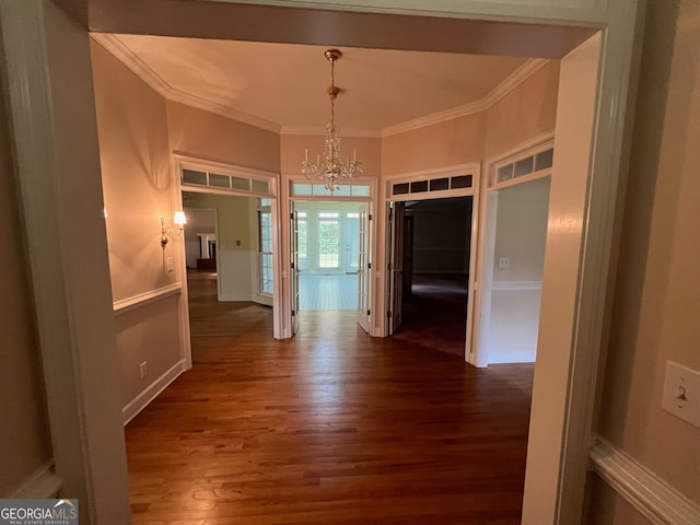 interior space featuring a chandelier, crown molding, and wood-type flooring