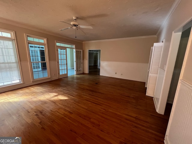 empty room with ornamental molding, hardwood / wood-style flooring, plenty of natural light, and ceiling fan