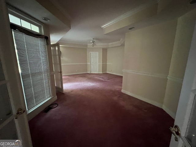 carpeted spare room featuring ornamental molding and ceiling fan