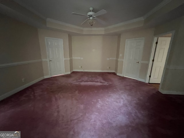 unfurnished bedroom with ornamental molding, carpet flooring, ceiling fan, and a raised ceiling