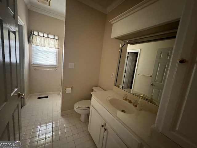 bathroom featuring tile patterned flooring, toilet, vanity, and ornamental molding