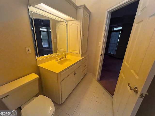 bathroom featuring vanity, toilet, and tile patterned floors