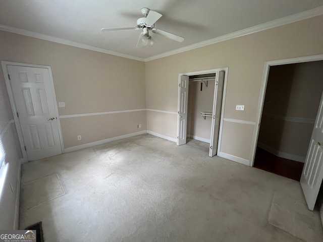 unfurnished bedroom featuring ornamental molding, multiple closets, and ceiling fan