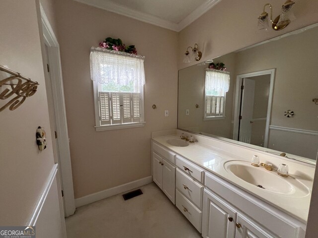 bathroom with ornamental molding and dual bowl vanity