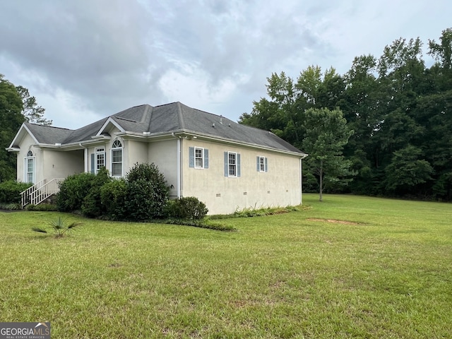 view of side of property with a yard