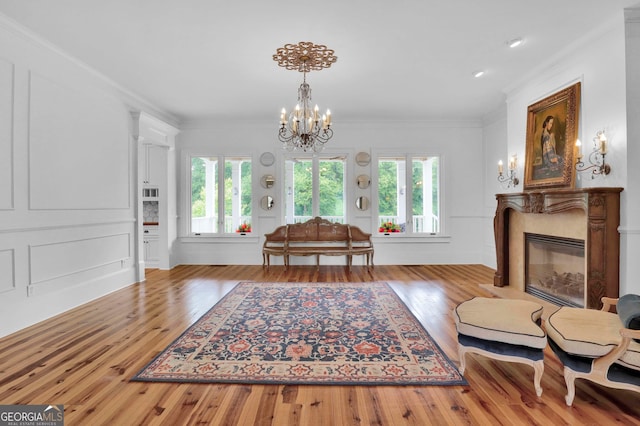 living room with plenty of natural light, ornamental molding, and hardwood / wood-style floors