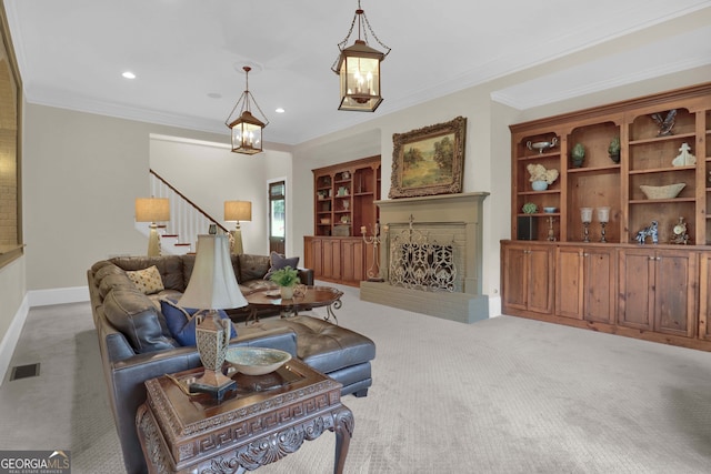 living room featuring crown molding, an inviting chandelier, built in shelves, light colored carpet, and a fireplace