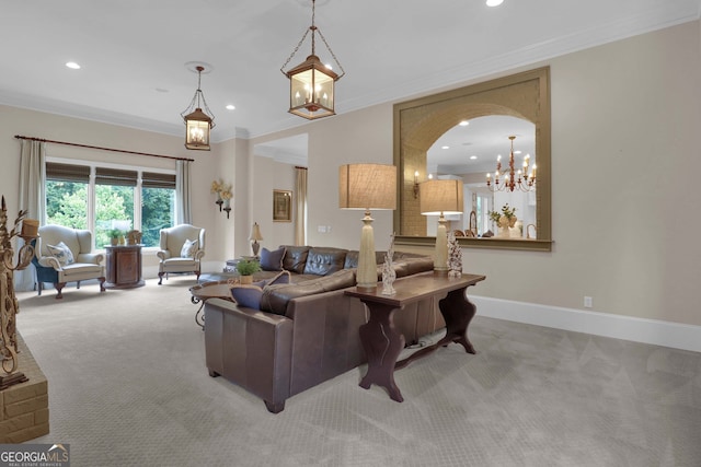 carpeted living room featuring a notable chandelier and ornamental molding