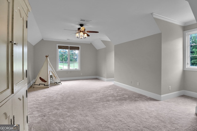 interior space featuring light carpet, vaulted ceiling, and ceiling fan