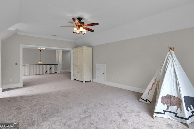 unfurnished living room featuring light carpet, vaulted ceiling, and ceiling fan