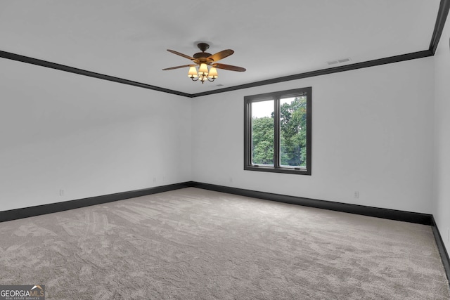 unfurnished room featuring ceiling fan, carpet flooring, and ornamental molding