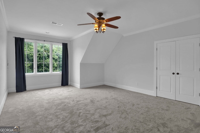 additional living space with light carpet, ceiling fan, and vaulted ceiling