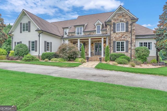 view of front of home featuring a front yard and covered porch