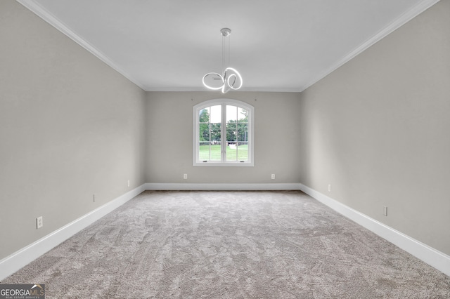 carpeted empty room featuring a notable chandelier and crown molding