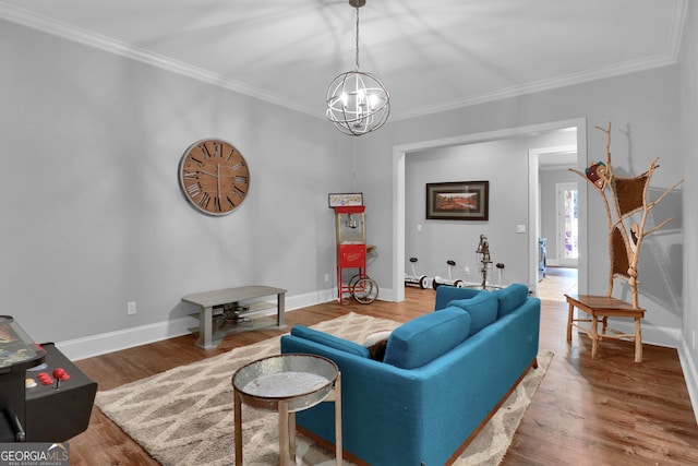 living room with a chandelier, wood-type flooring, and ornamental molding