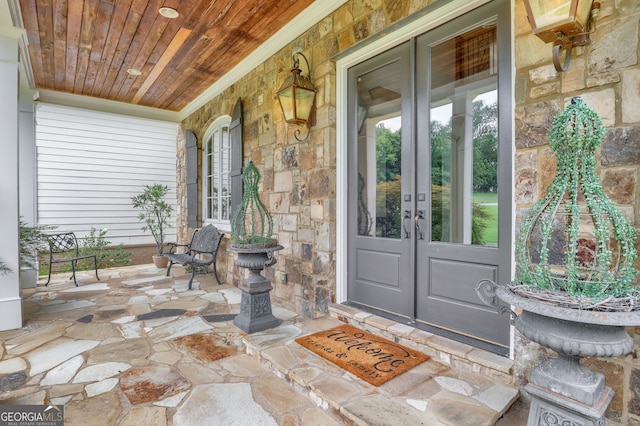 view of exterior entry featuring a porch