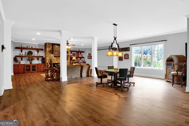 dining area with crown molding, ceiling fan, and wood-type flooring