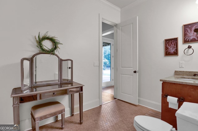 bathroom featuring vanity, tile patterned floors, crown molding, and toilet