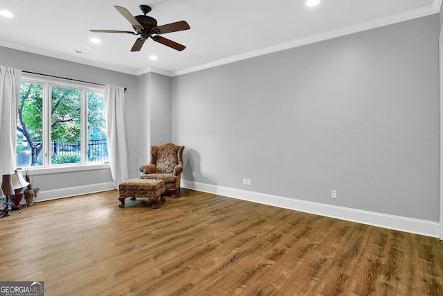 sitting room featuring crown molding, ceiling fan, and wood-type flooring