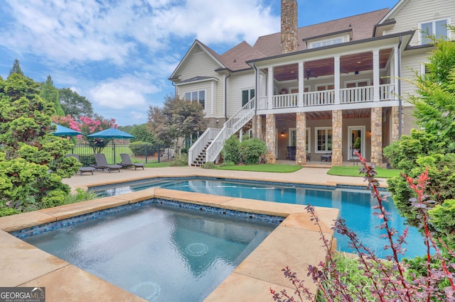 view of swimming pool featuring a patio area and an in ground hot tub