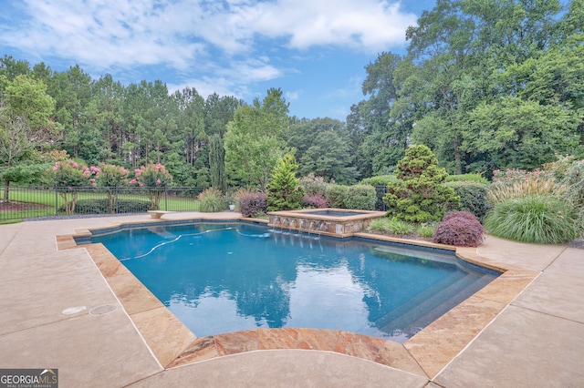 view of pool with an in ground hot tub